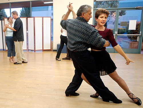Sue Lindenberg, dance instructor and owner of Tango Fantástico, is led by Bernardo Lucero as she teaches a move during a recent class in Morgan Hill.