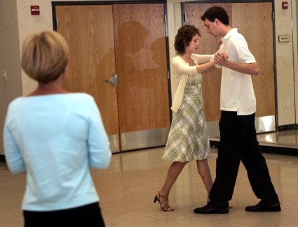 Working under the watchful eye of instructor Sue Flanagan (left), dancers Alone Gorer and Alex Baxter practice their tango steps.